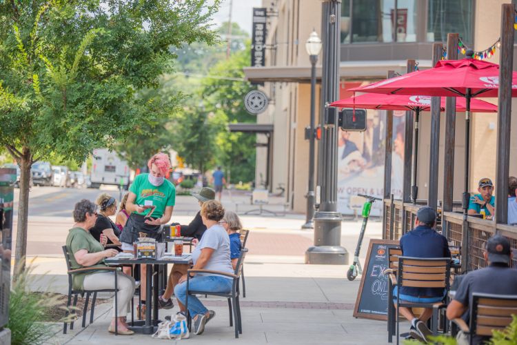 Residences at capitol view people enjoying lunch on a patio in the gulch neighborhood