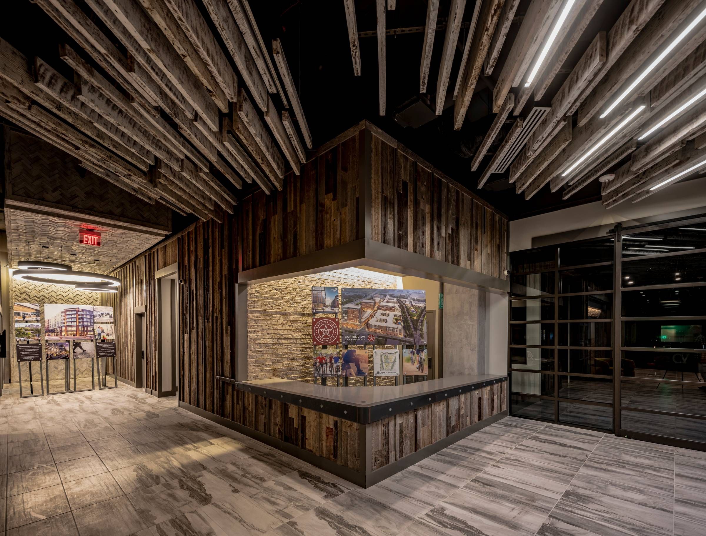 Residences at Capitol View resident lobby area concierge desk with modern lighting overhead