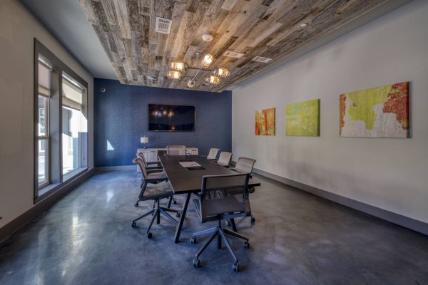 Residences at Capitol View modern resident conference room with large table and tv on the wall