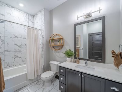 Residences at capitol view luxury apartment bathroom with dark vanity and white tile