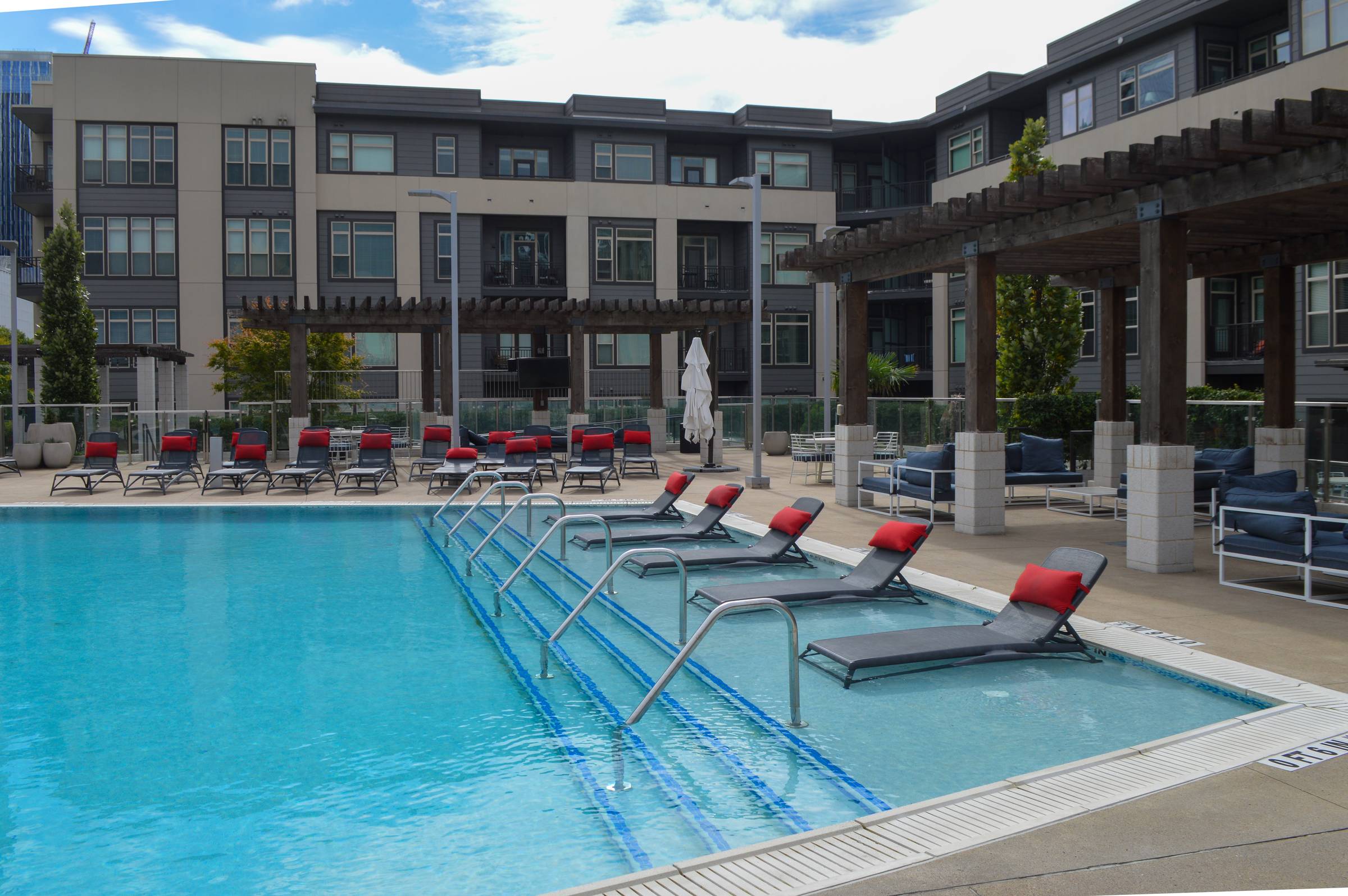 Residences at Capitol View luxury pool amenity with beach style seating