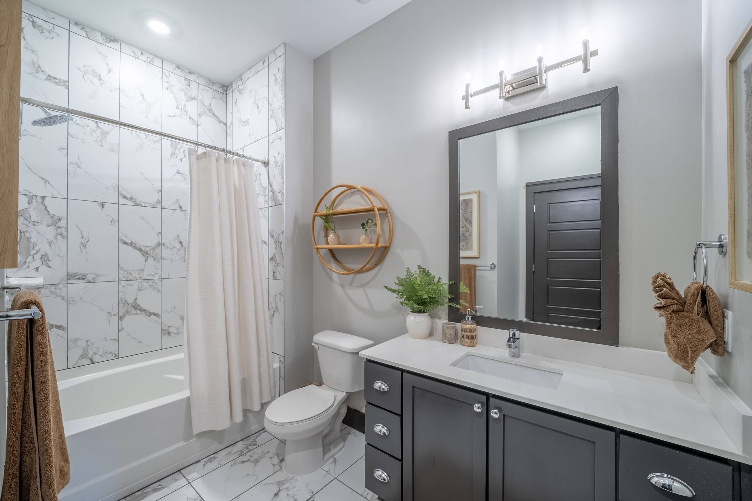 Residences at capitol view luxury apartment bathroom with dark vanity and white tile