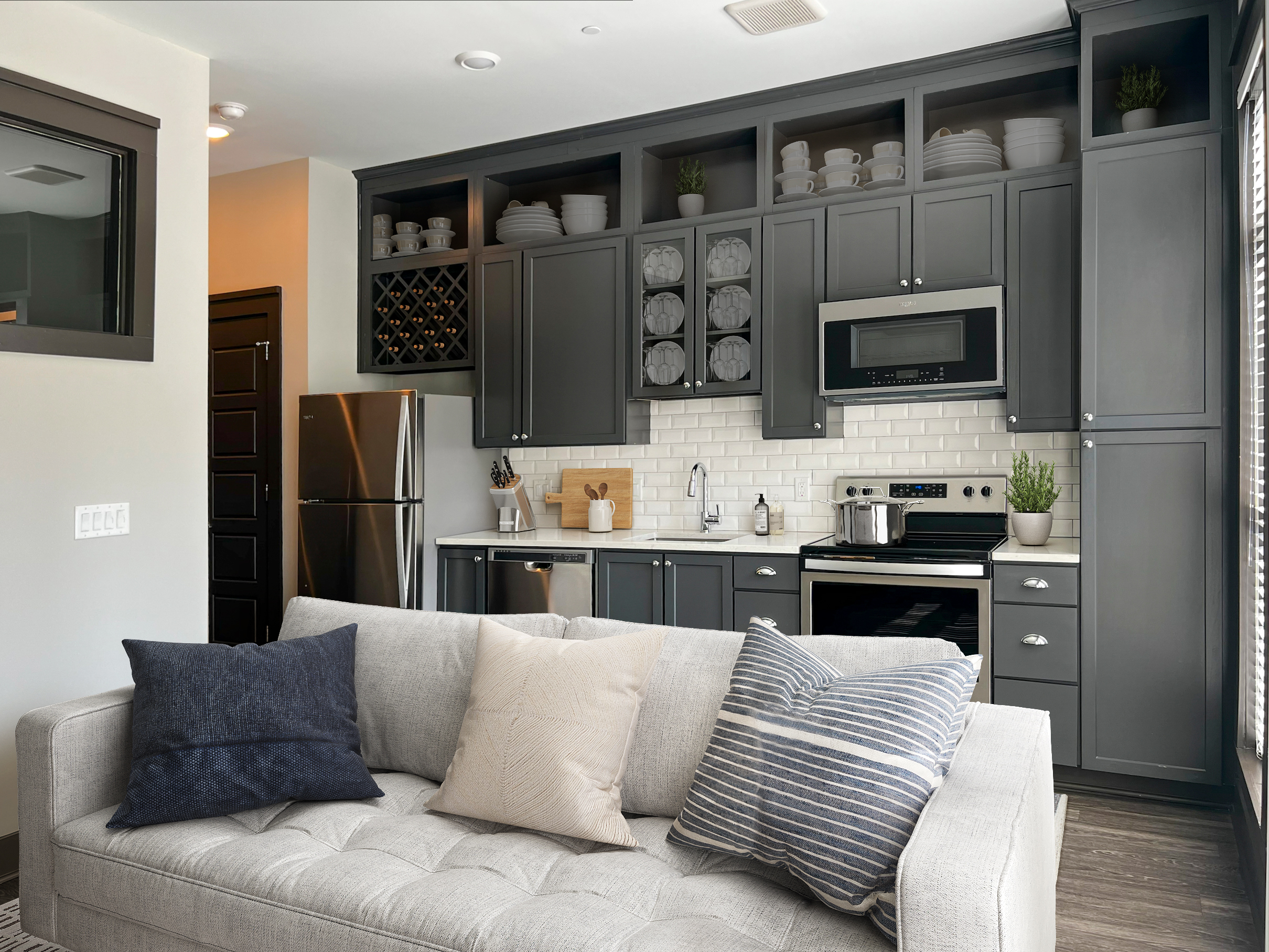 Residences at Capitol View luxury apartment interior with grey couch and wooden coffee table